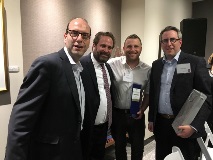 Group photo of four men smiling