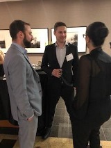 People talking at formal social gathering
