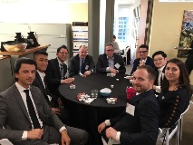 Group of people at poker table smiling at camera