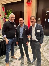 Three men smiling at camera