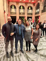 Four people smiling at camera