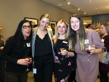 four women smiling at camera