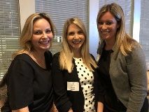 three women smiling at camera
