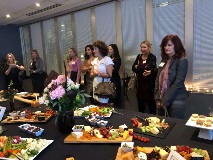 Group of people standing around food table