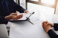 Lawyer with a clipboard talking to a client