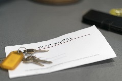 Eviction notice slip under some keys on a table