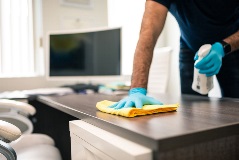 Cleaners wiping down office tables