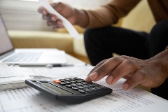 A client calculating taxes with a calculator