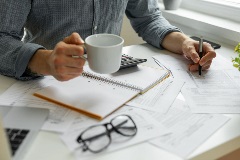 A man working with coffee in hand