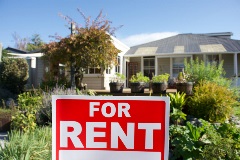 For rent sign on front lawn of home