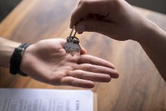 Real estate agent handing over keys to tenant