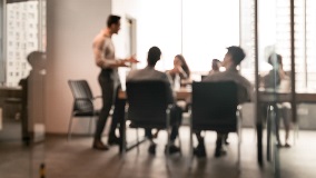 Colleagues deliberating in the boardroom