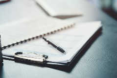 Clipboard with a form and a pen