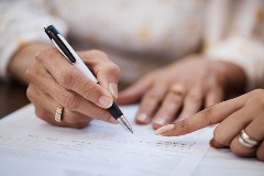 Lawyer showing client where to sign