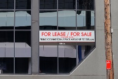 For lease / for sale sign on a commercial building