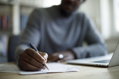 A student studying and taking notes