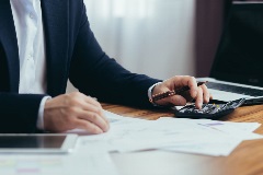 Accountant looking over numbers and using a calculator