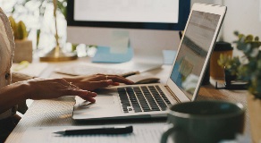 Close up of person typing on laptop