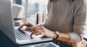 Close up of person working at laptop